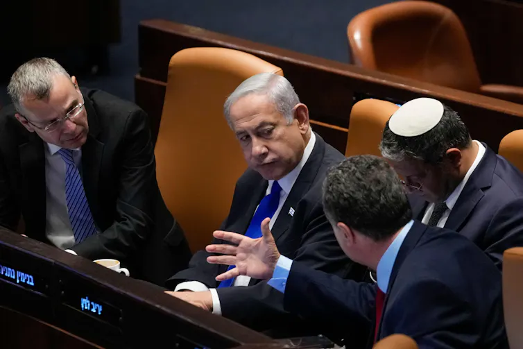 Israeli prime minister, Benjamin Netanyahu, speaks with ministers in the Knesset including national security minister, Itamar Ben Gvir, and minister of defence, Israeli Katz.