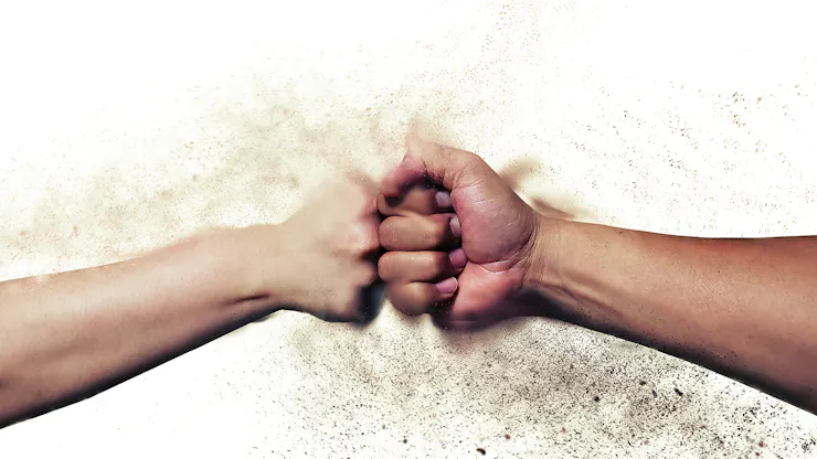 Two fists, colliding.