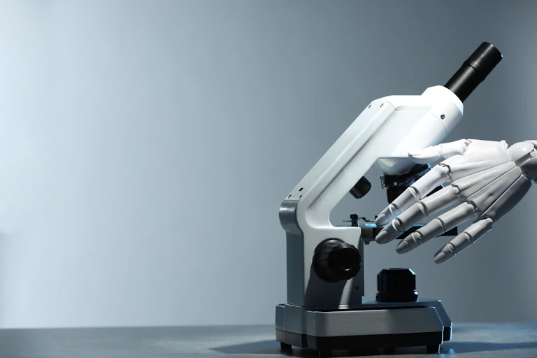 Hand of robot adjusting a microscope