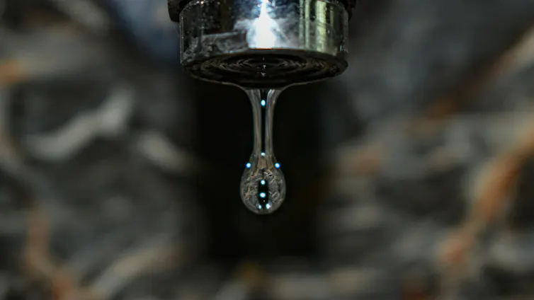 Water dripping from a faucet.