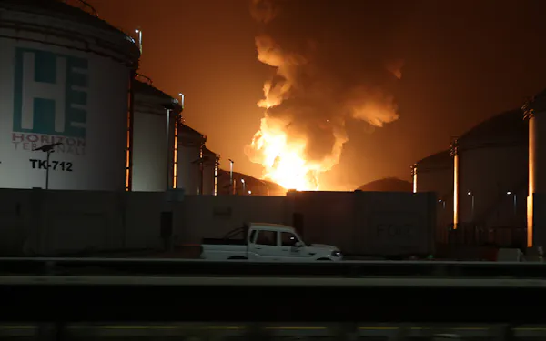 Orange flames rise during a fire caused by an intercepted drone at an oil refinery hub in the United Arab Emirates.