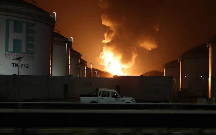 Orange flames rise during a fire caused by an intercepted drone at an oil refinery hub in the United Arab Emirates.