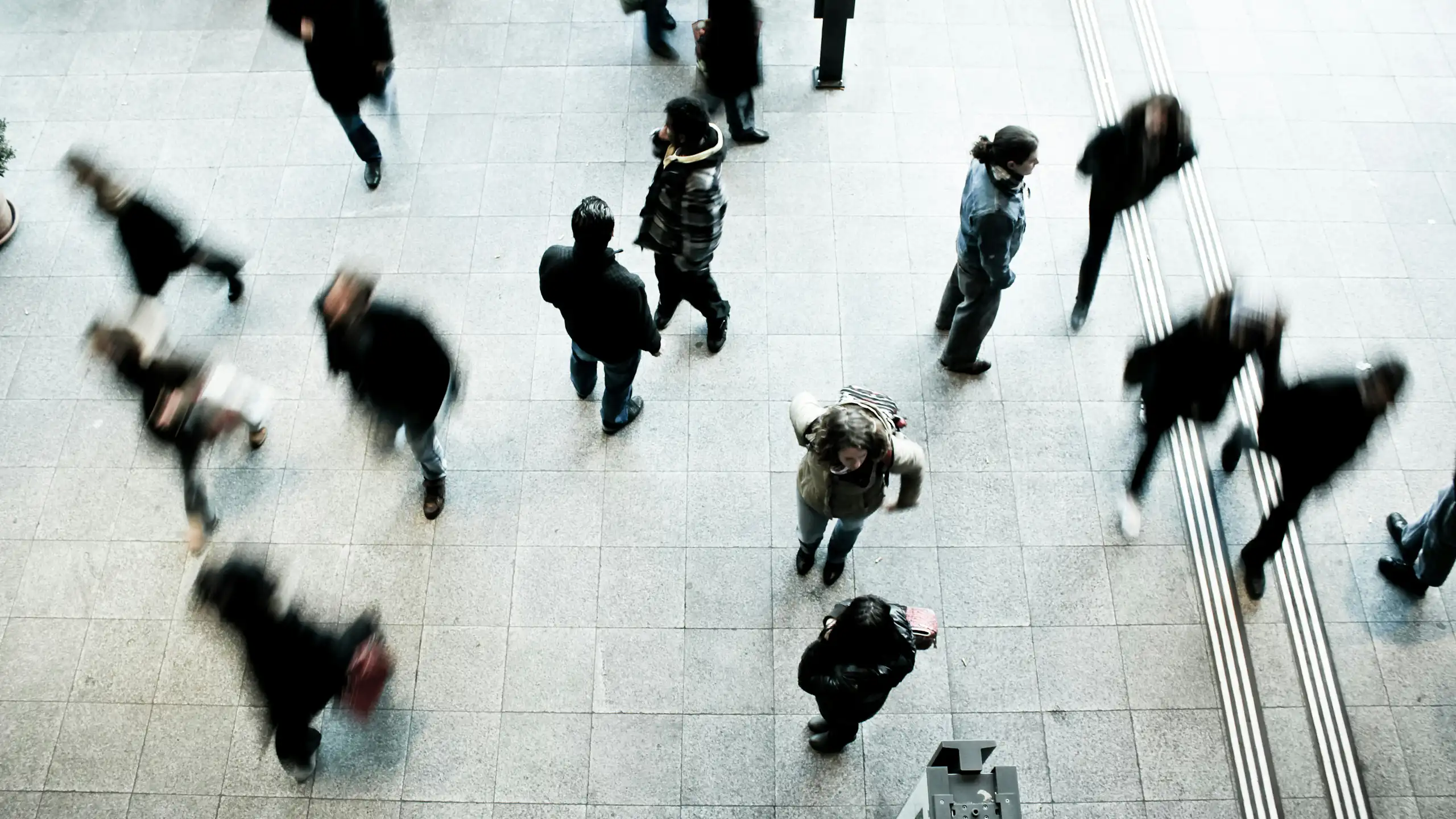 People walking past each other, with some not clearly visible