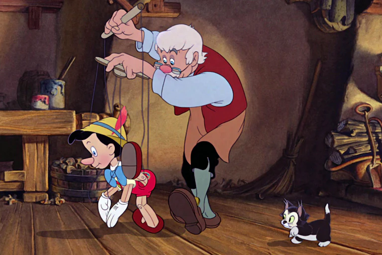 A still from a Disney animation with a wooden puppet on strings and an old toymaker.