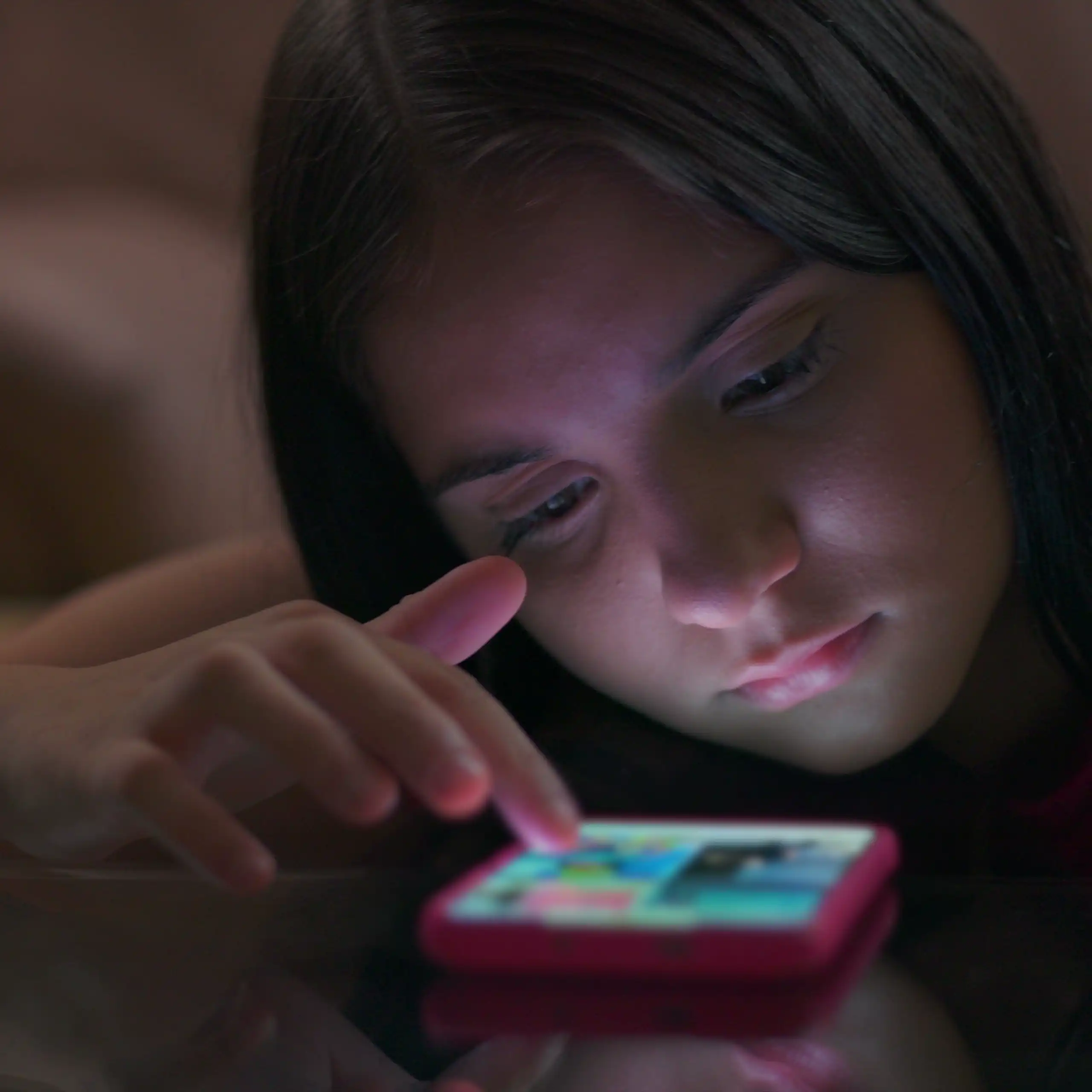 A girl scrolling on a mobile phone.