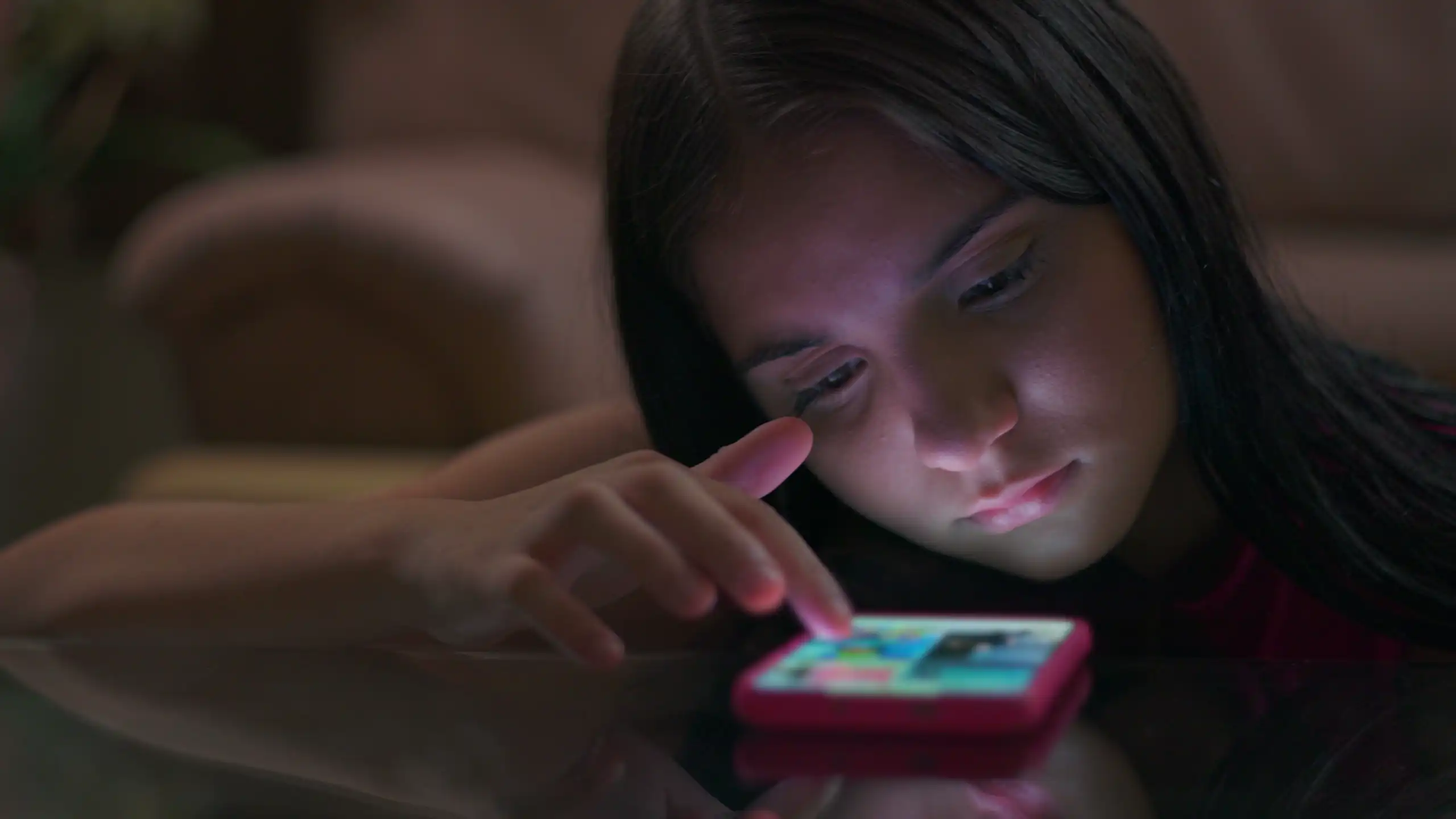 A girl scrolling on a mobile phone.