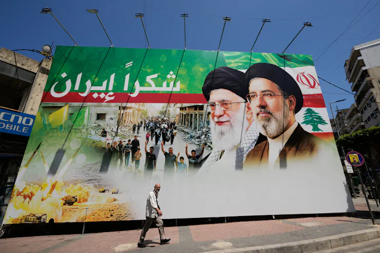A man walks by a giant billboard.