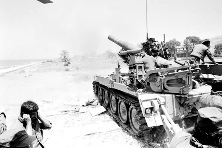 A tank fires in a black and white photo.