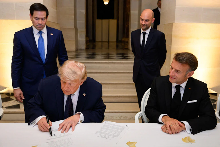 US president, Donald Trump, signs a document flanked by US Secretary of State Marco Rubio, Trump, French Foreign Minister Jean-Noël Barrot and French President Emmanuel Macron.