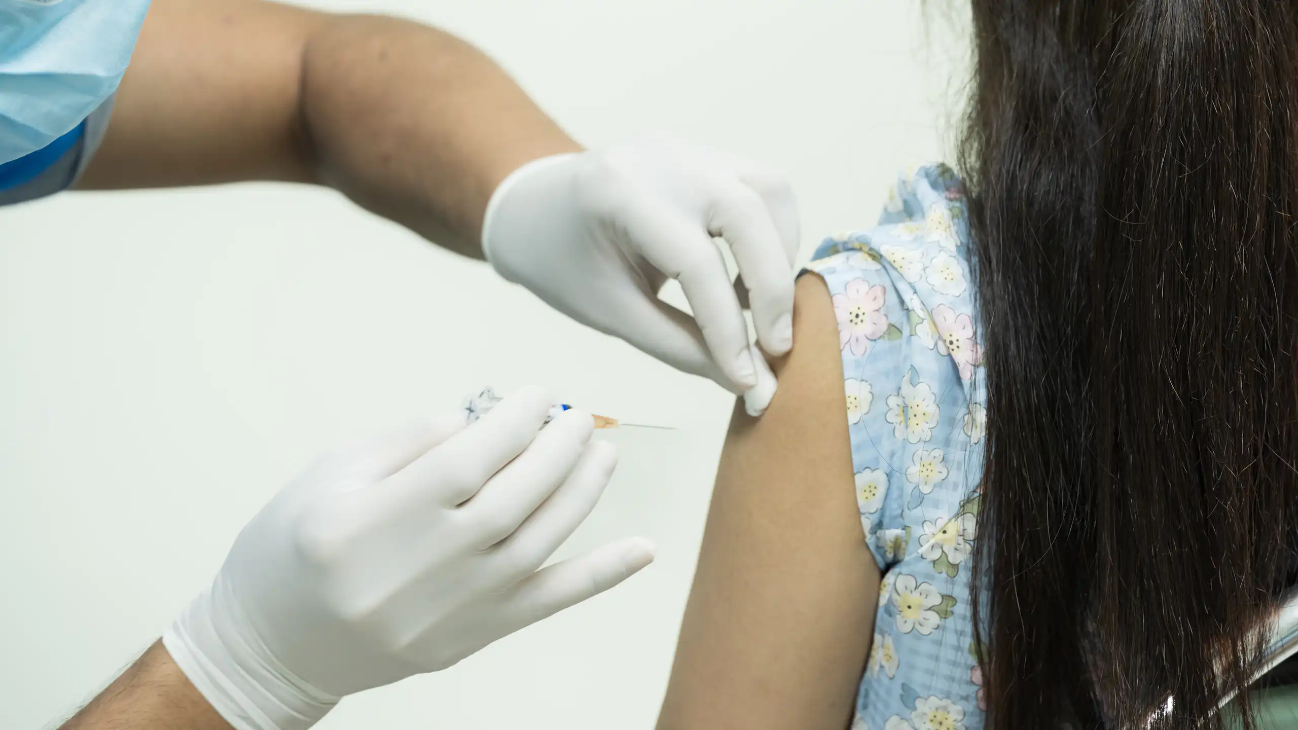 A girl receives a vaccine.