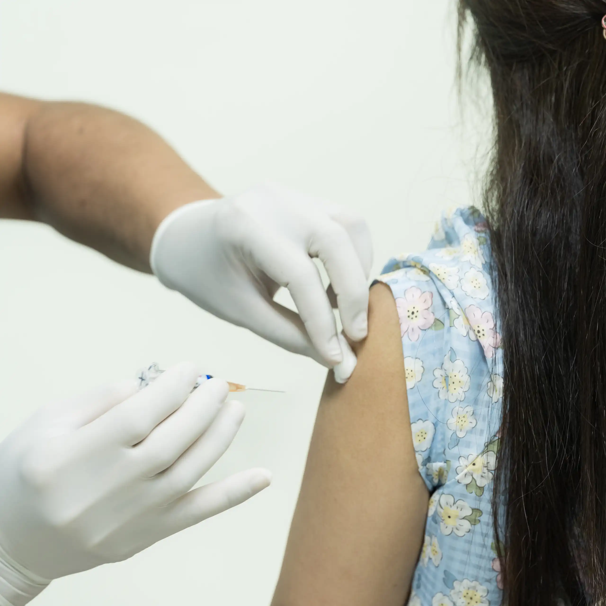 A girl receives a vaccine.
