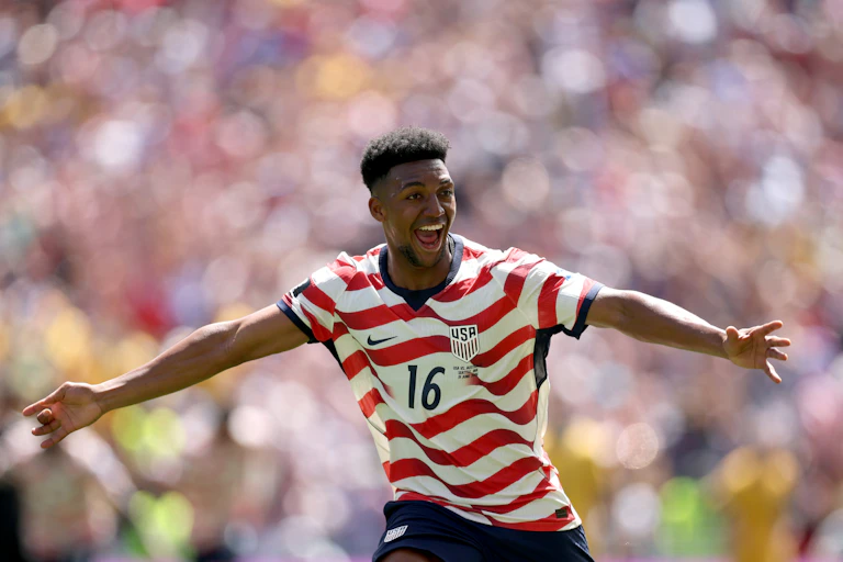 American soccer player with arms wide
