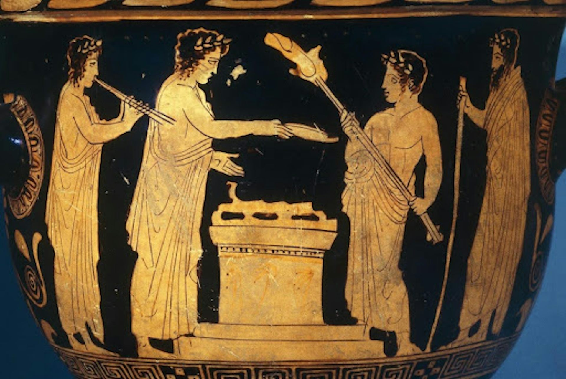 Greek pottery showing a ritual sacrifice on an altar. The person to the left of the altar holds a large hunk of meat on a spit.