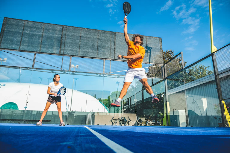 Two people playing padel