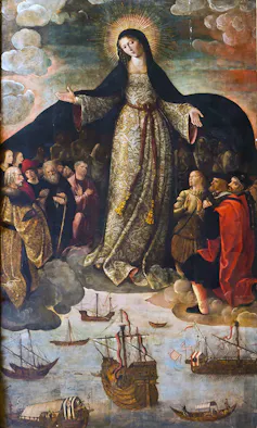 A painting shows a woman with a halo, draping her cloak over a small crowd of men praying on their knees.