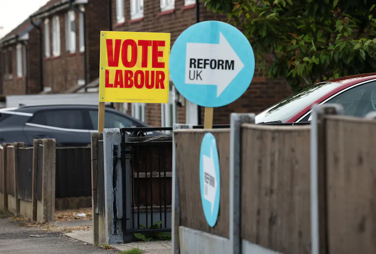 competing labour and reform uk placards posted on neighbouring houses.