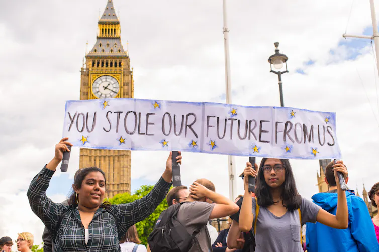 Young protestors holding a banner stating 'You stole our future from us'