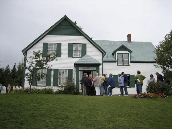A white home with green gables.