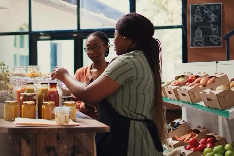 Two women bottling vegetables