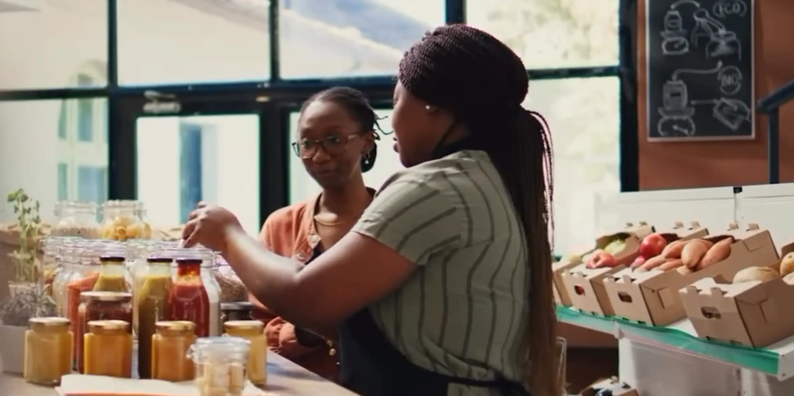 Two women bottling vegetables