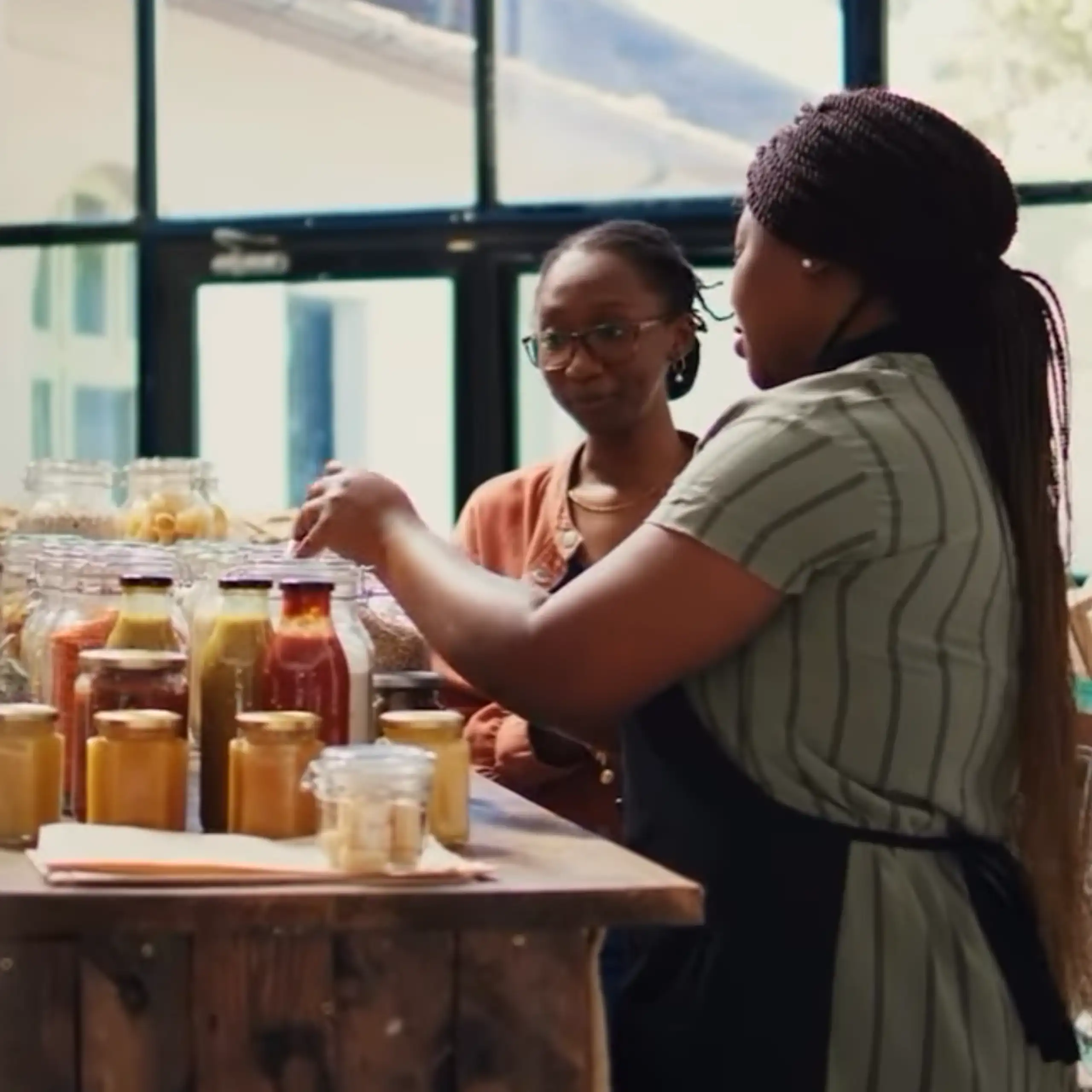 Two women bottling vegetables