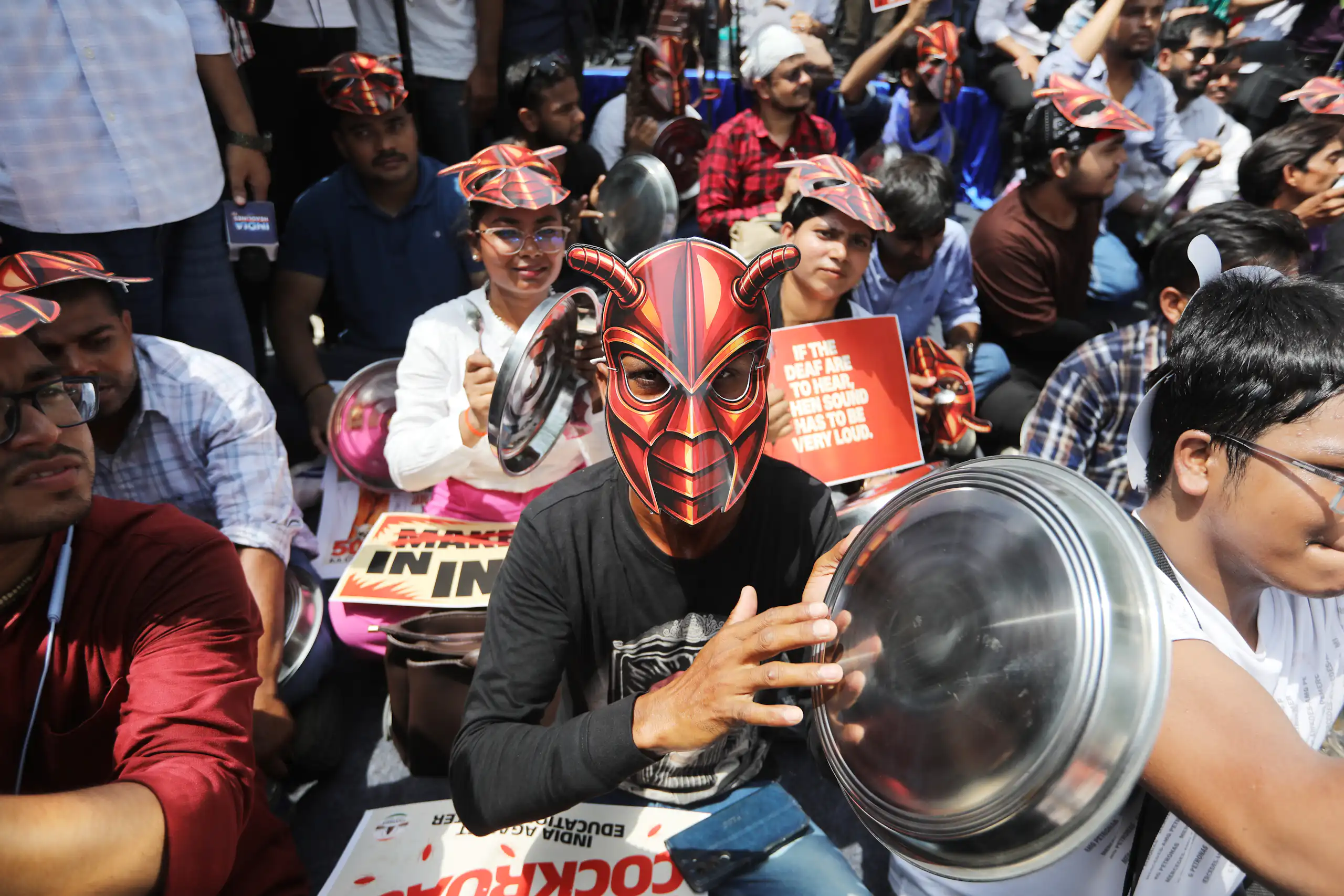 A protester with a cockroach mask at a protest in New Delhi.