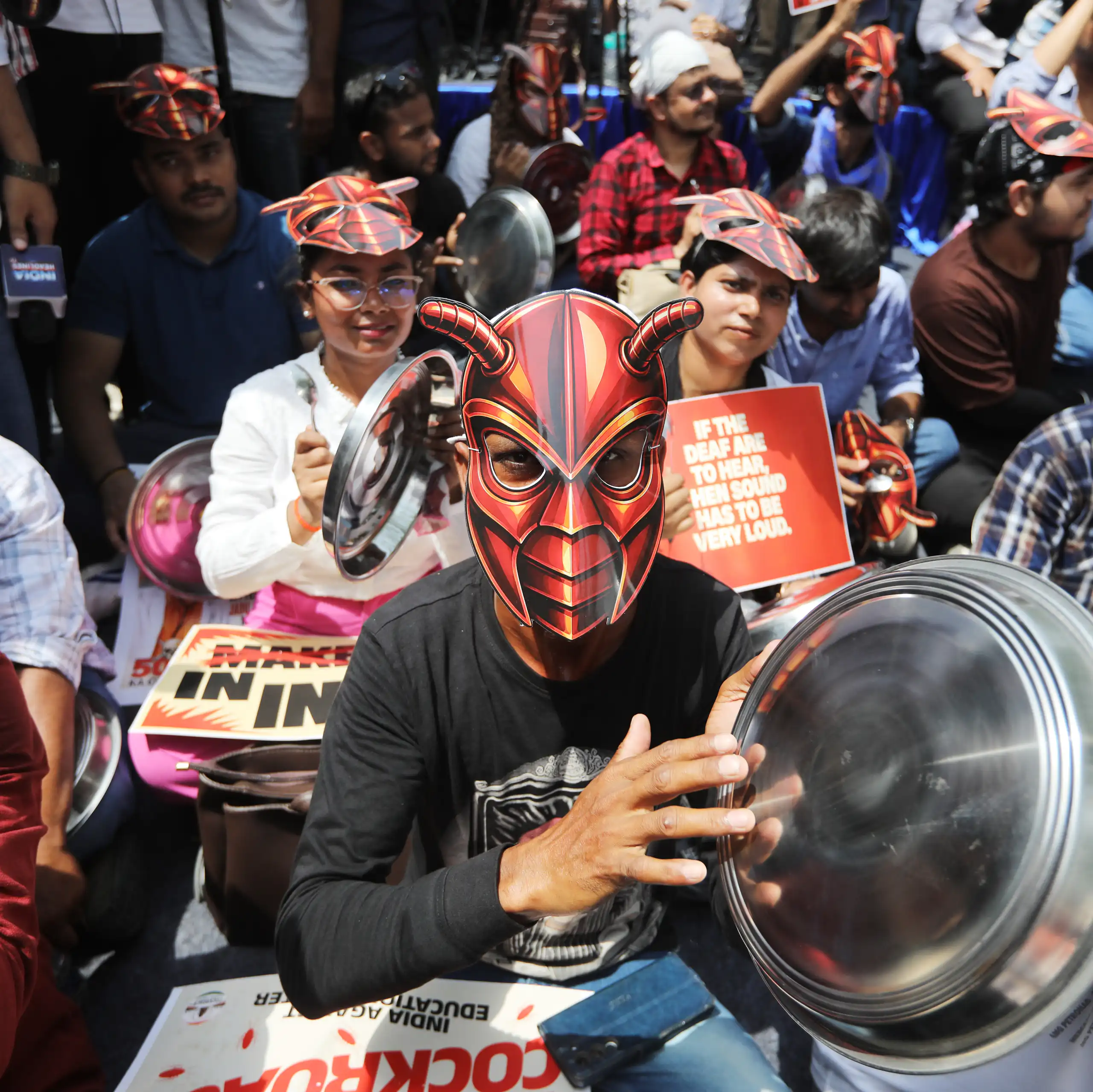 A protester with a cockroach mask at a protest in New Delhi.