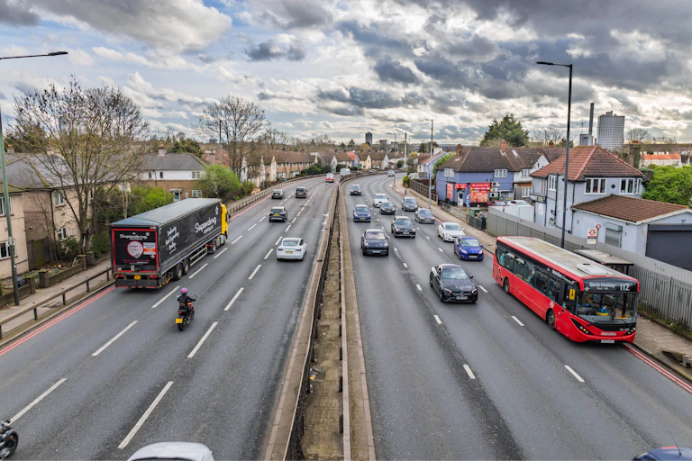 overhead view of a multilane highway with cars and buses