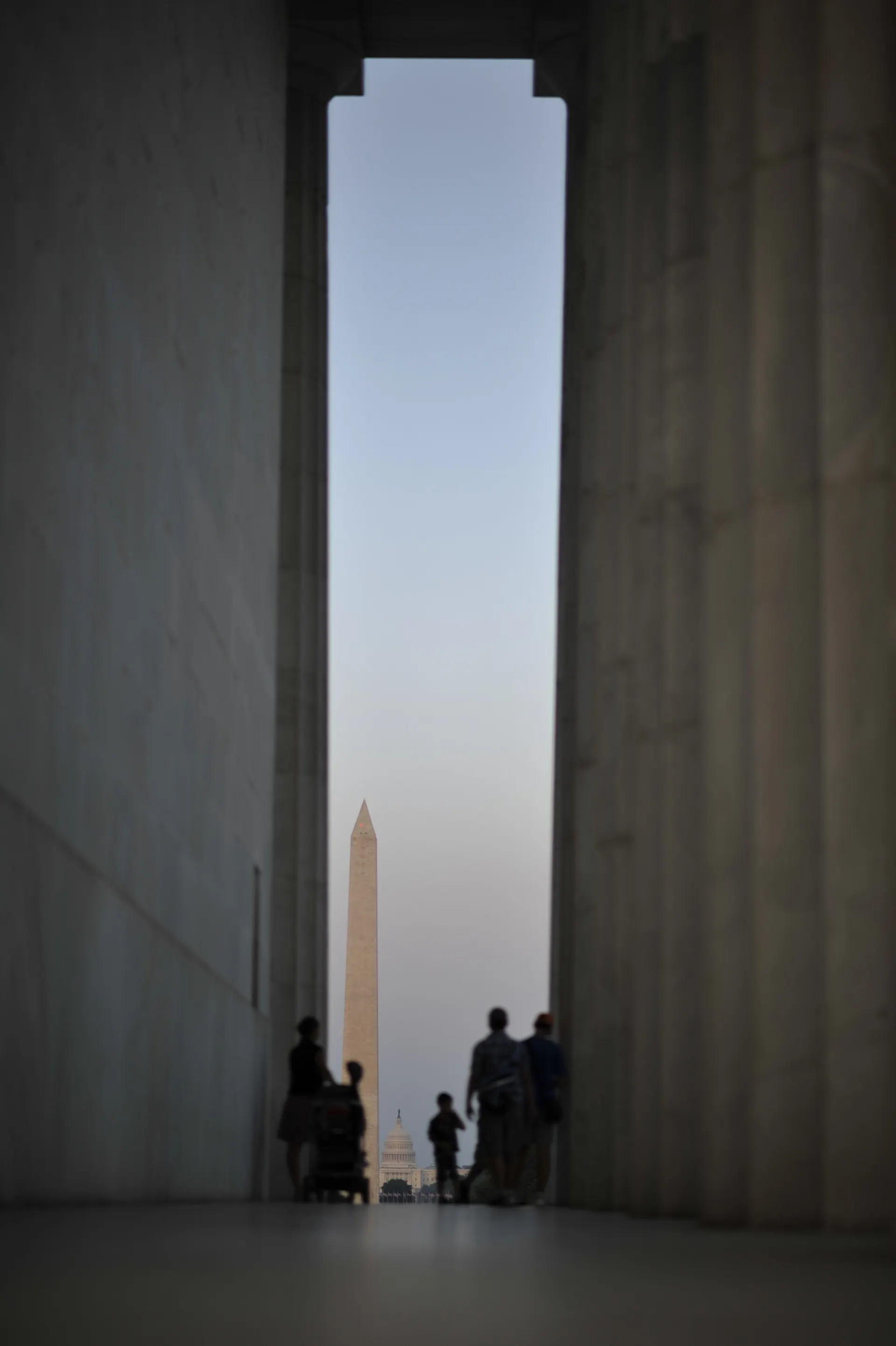 A sliver of a view from a tall open space to the Washington Monument's obelisk.