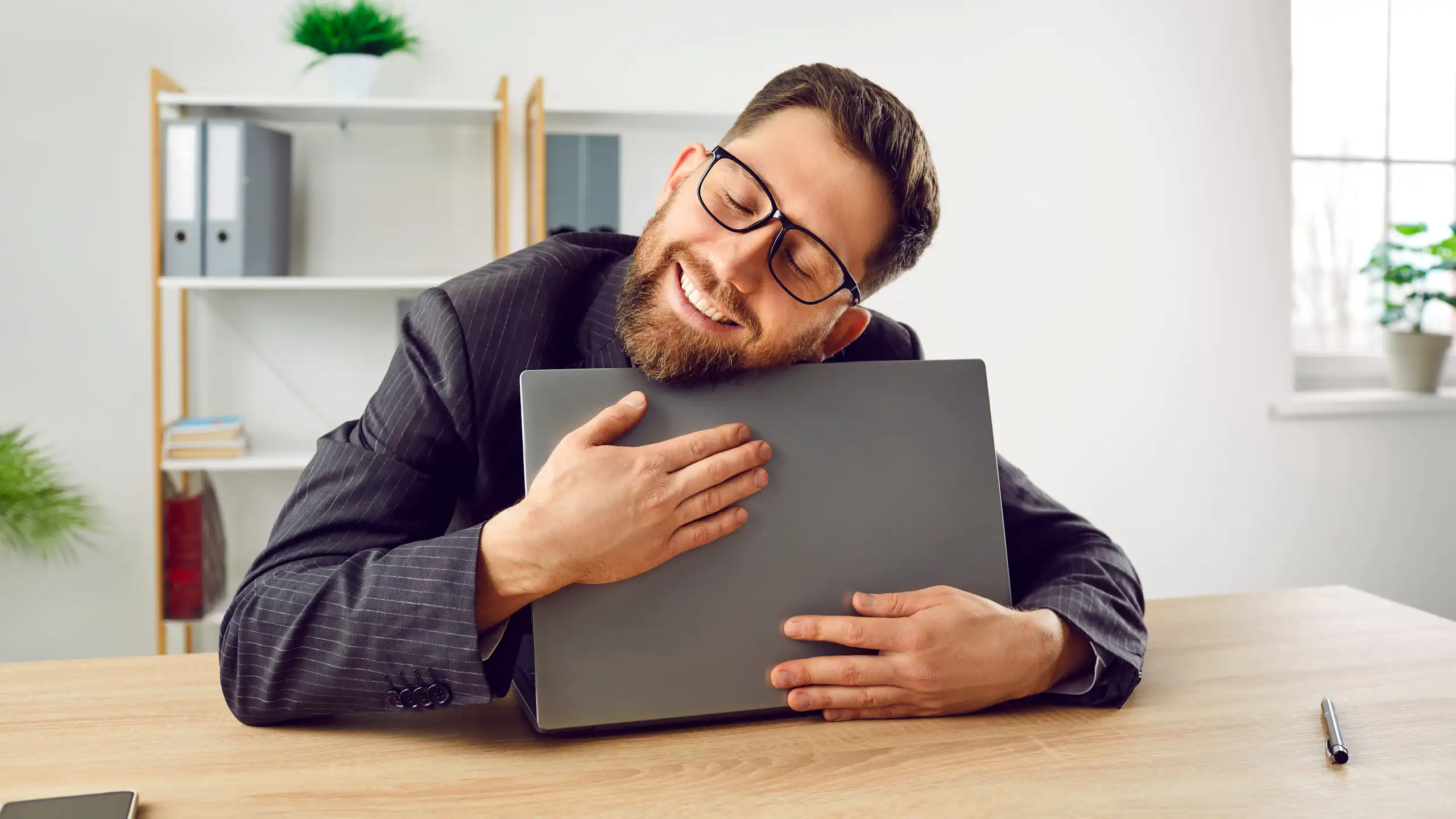 Une personne avec son ordinateur dans les bras.