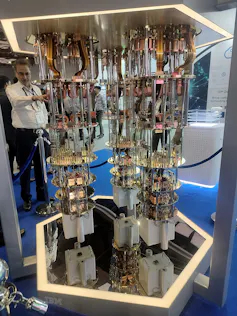 A machine made up of metal disks, rods and electronics, on display in an exhibition hall