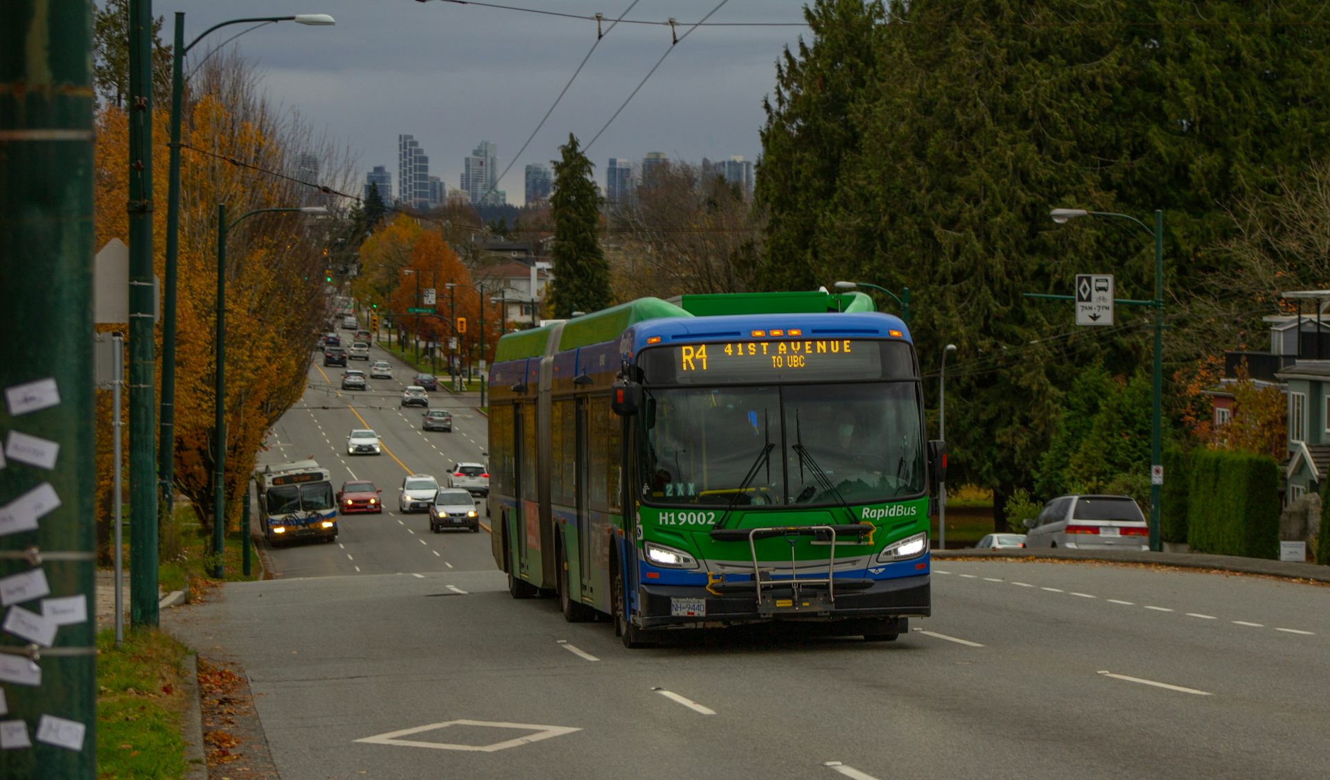 A long green bus on a road
