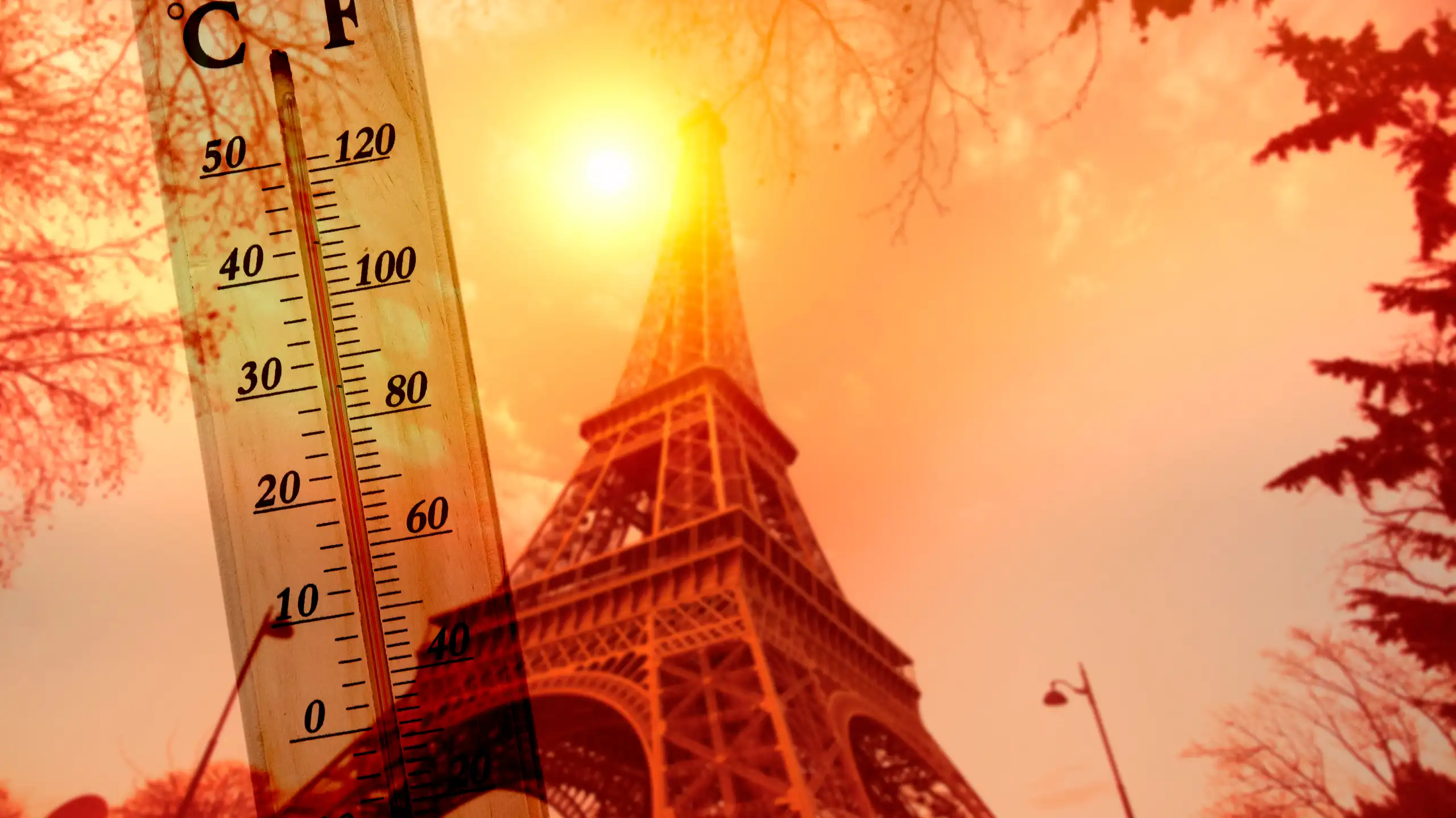 A picture of the Eiffel tower basking in the hot sun with a thermometer displaying a high temperature.