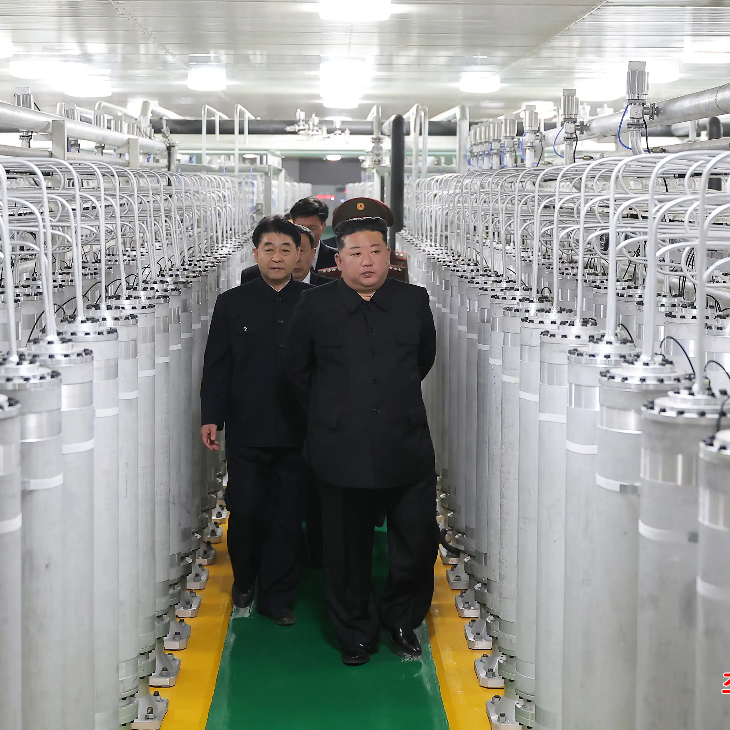 North Korean leader Kim Jong Un (C-R) as he inspects a nuclear materials production factory at an undisclosed location in North Korea