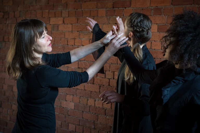Guerin in the rehearsal room with two dancers.