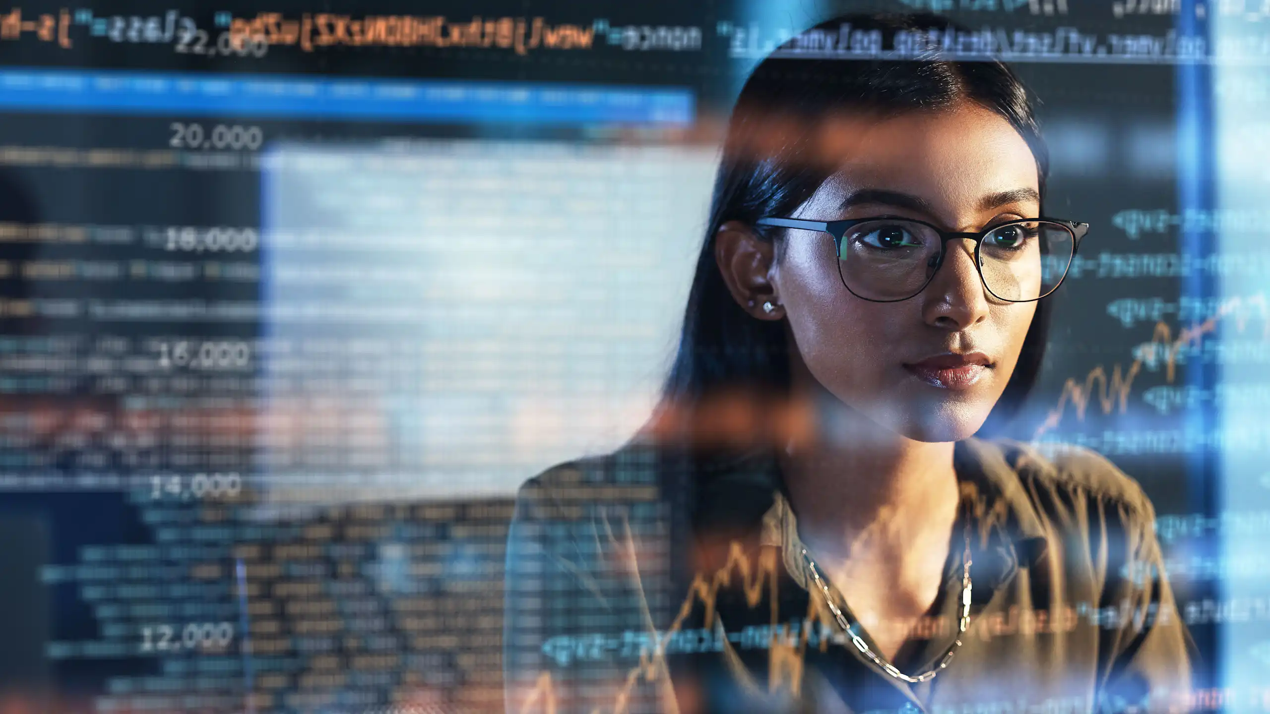 Femme devant un écran numérique avec des lignes de code.
