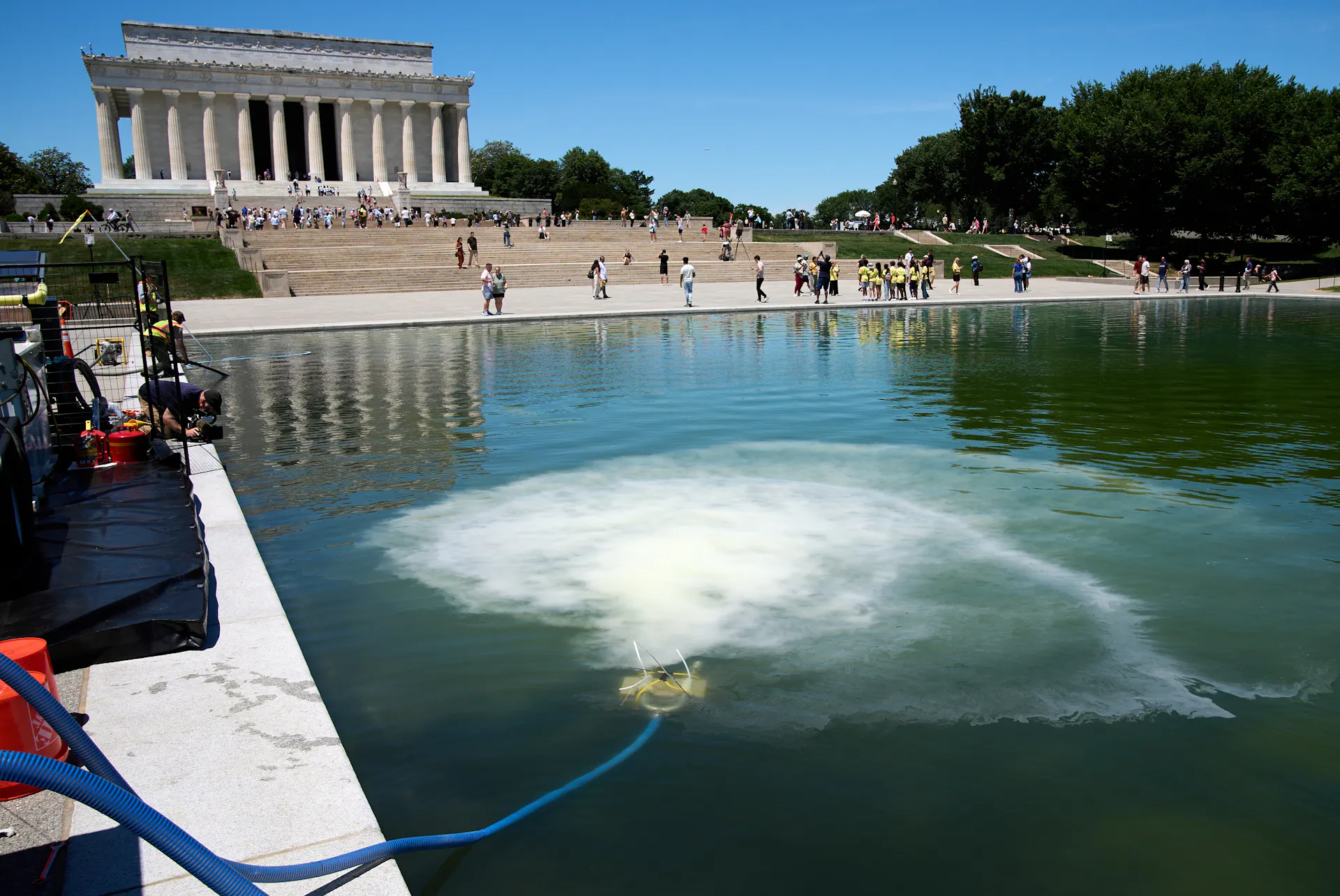 A tube into the Reflecting Pool, with the Jefferson Memorial in the background, puts out white bubbles.