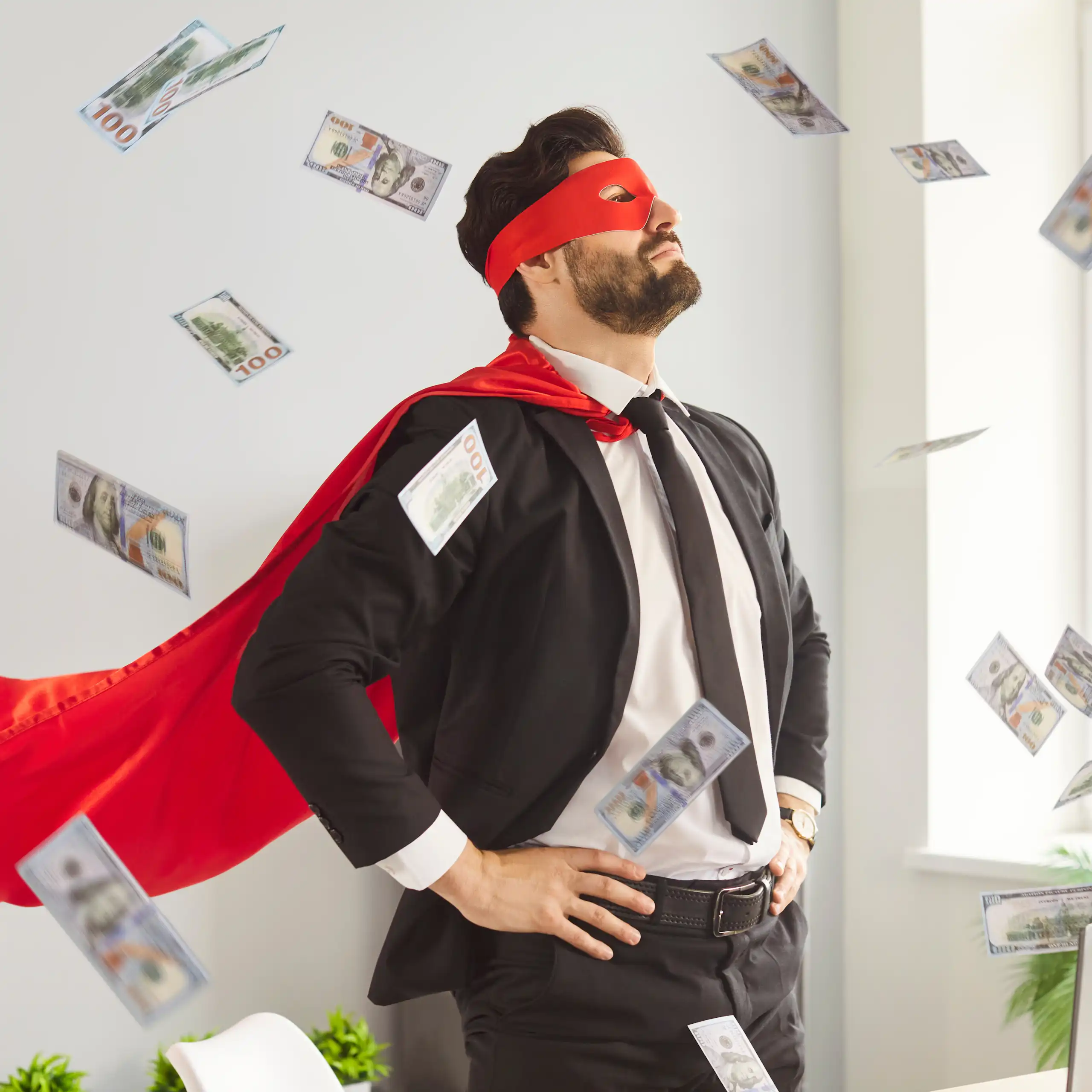 Un homme en costume de superhéros sous une pluie de billets de banque.