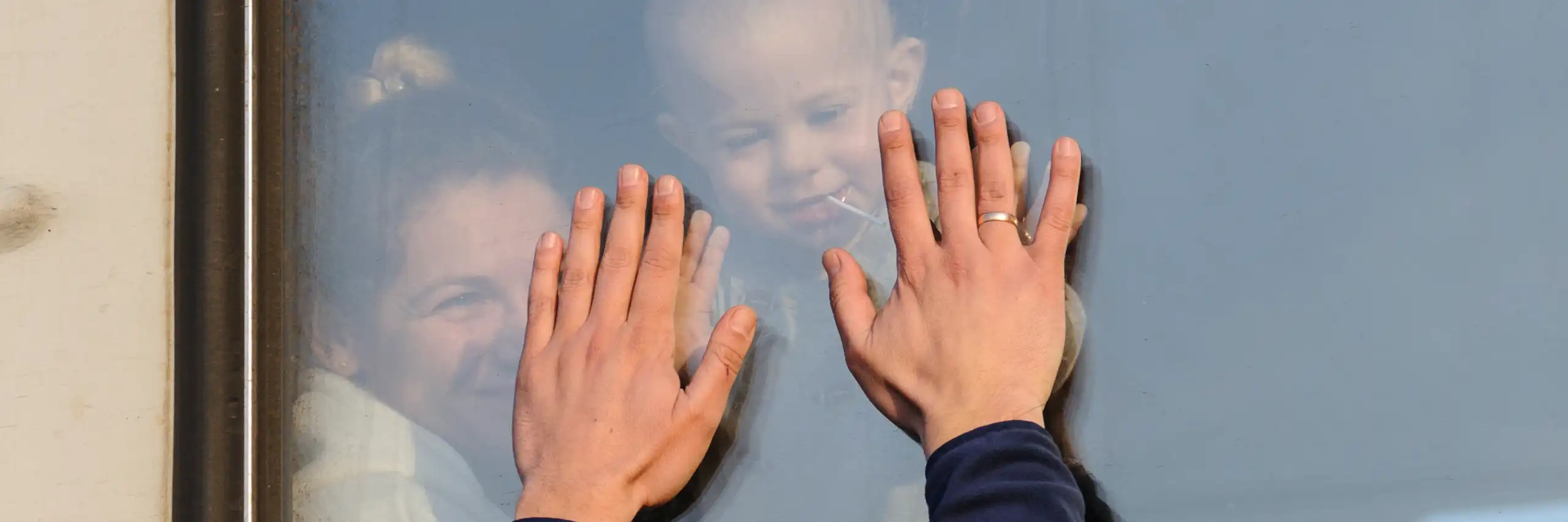 Ukrainian refugees wave goodbye as they depart on a train.