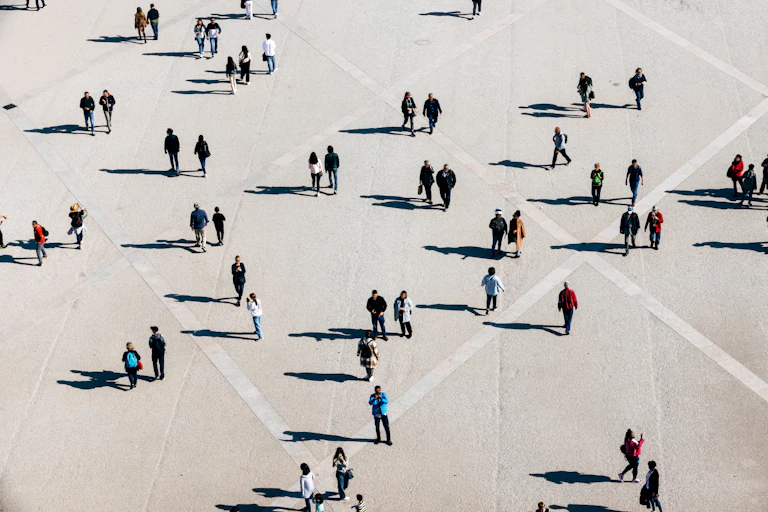 Aerial view of large number of people walking on the city square on the sunny day
