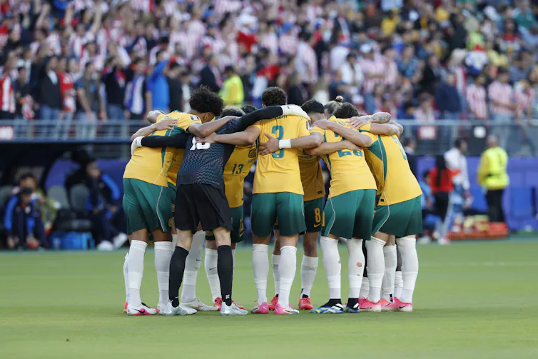 The Socceroos in a huddle before the Paraguay game.