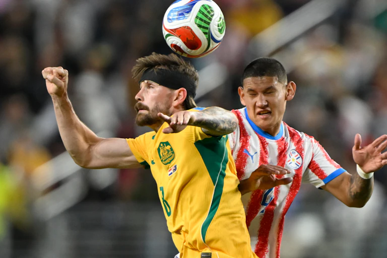 Australia's Connor Metcalfe battles for the ball against Paraguay.