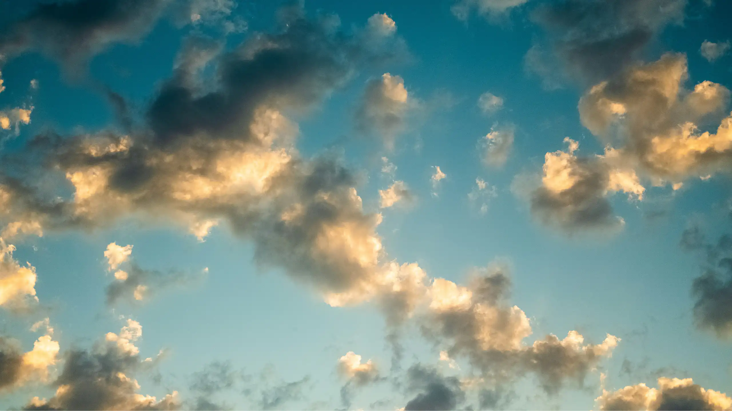 Sunlit clouds against a blue sky