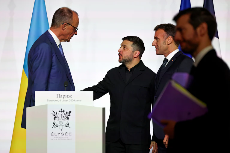 Germany's Chancellor Friedrich Merz (L) speaks with Ukraine's President Volodymyr Zelensky (C) and France's President Emmanuel Macron at a meeting of the coalition of the wiling in Paris, January 6 2026.