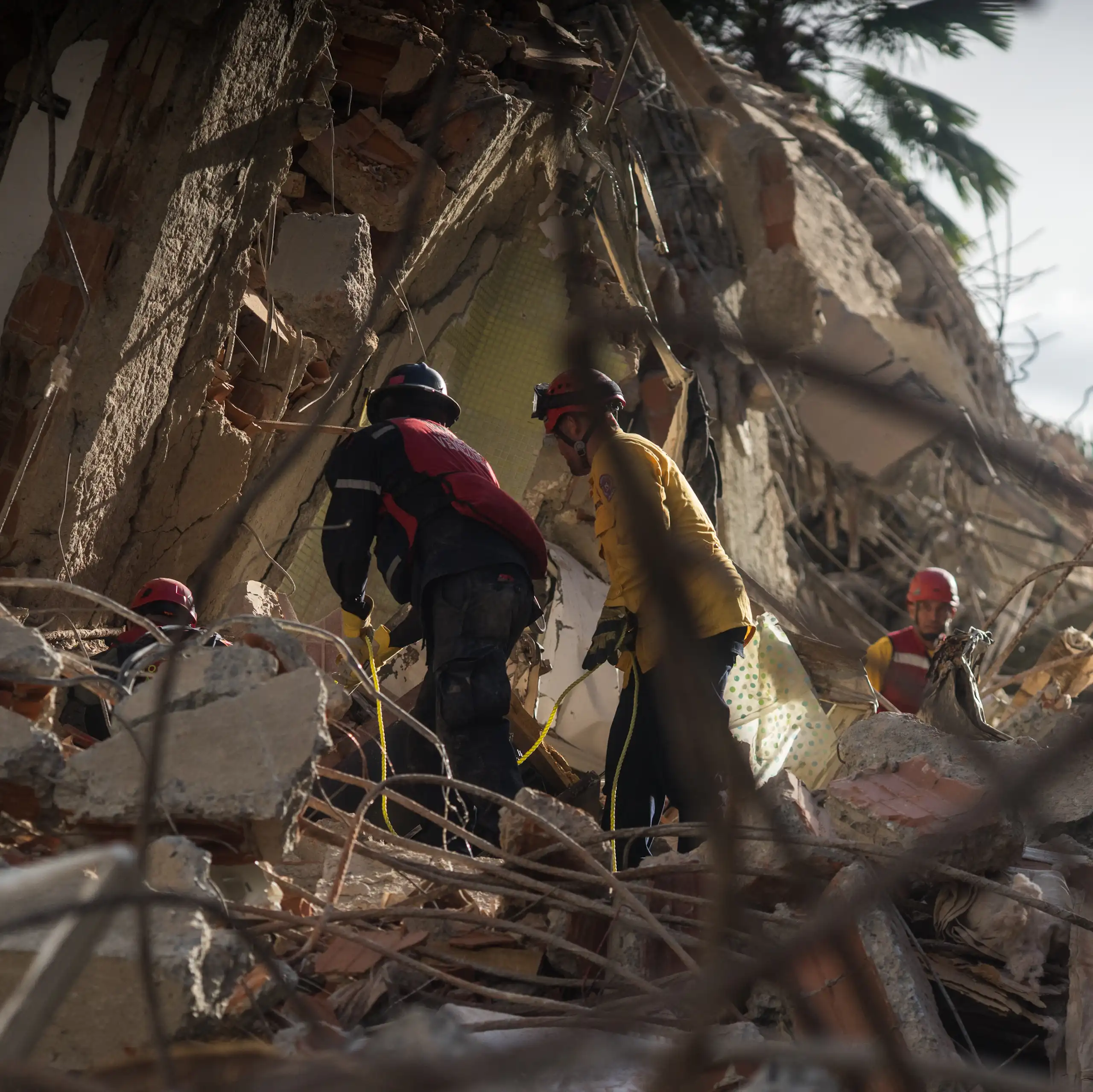 Rescue workers in Caracas search a building damaged by earthquakes.