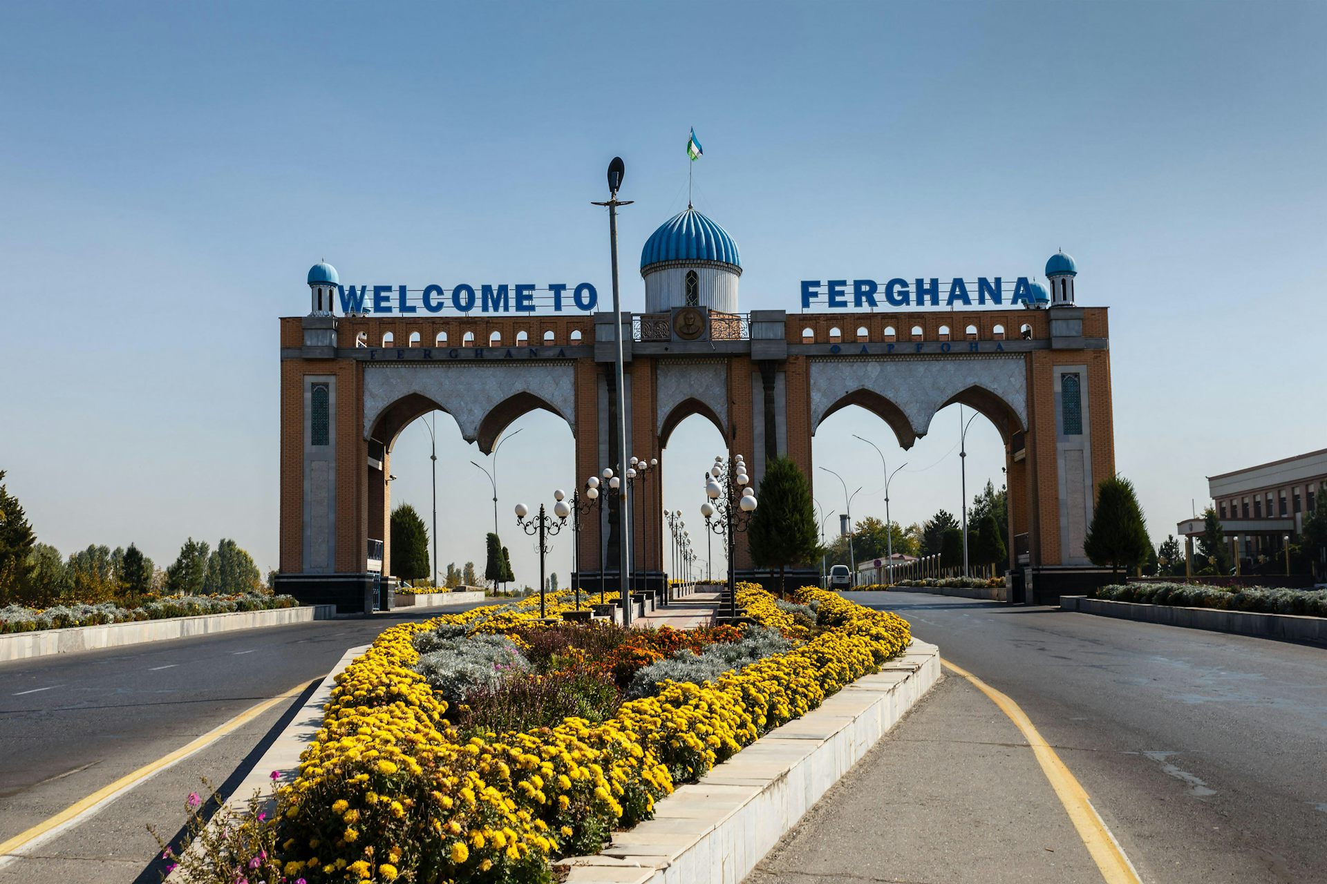 An archway with the sign Welcome to Ferghana.