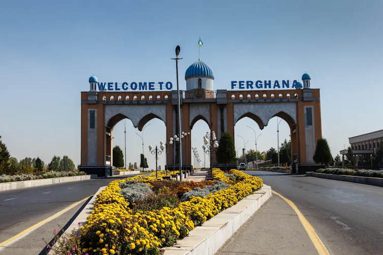 An archway with the sign Welcome to Ferghana.