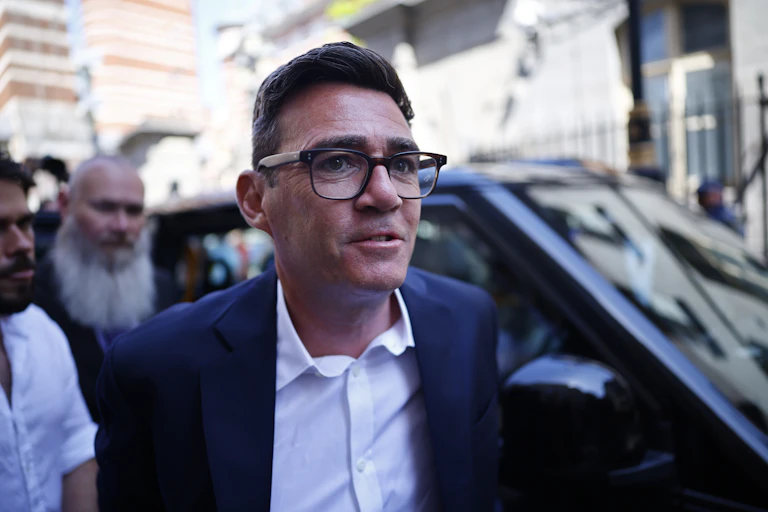 andy burnham gets out of a taxi after arriving in london to be sworn in as an mp in parliament.