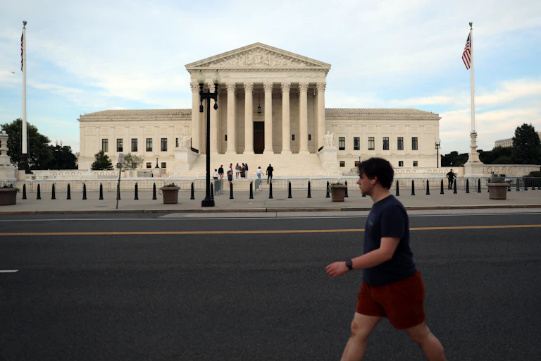 A man walks past a federal building.