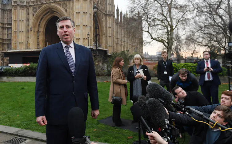 graham brady outside the houses of parliament speaking to gathered media.